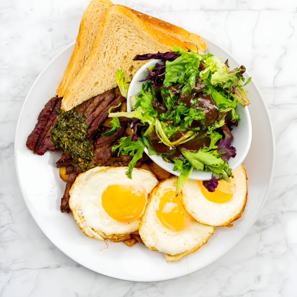 Bite Food & Coffee Co's breakfast steak and eggs with toast and a side salad.
