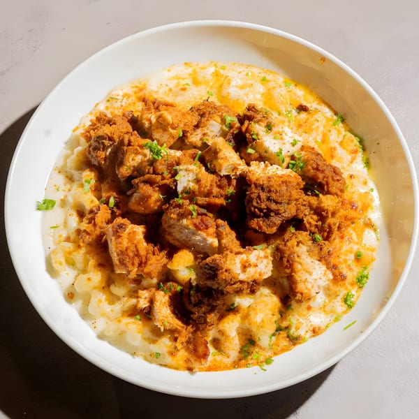 Bite Food & Coffee Co's creamy mac and cheese topped with crispy fried chicken and fresh parsley.